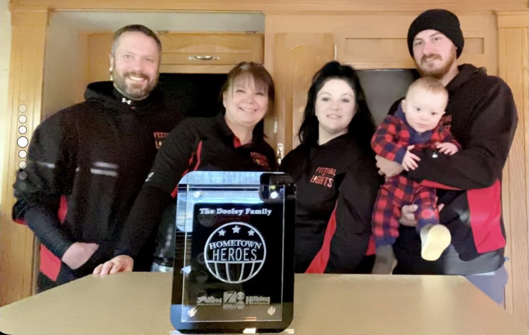 The Dooley family gathered with their Hometown Heroes award.